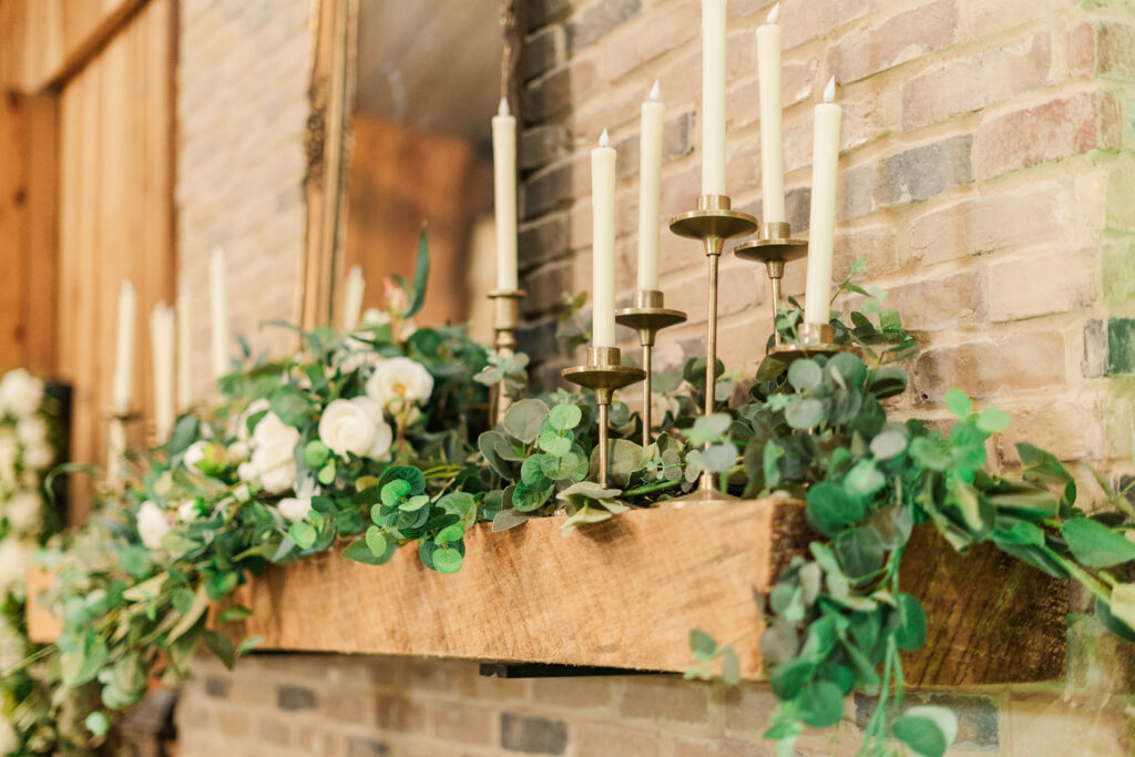 fire place mantle with greenery and candles