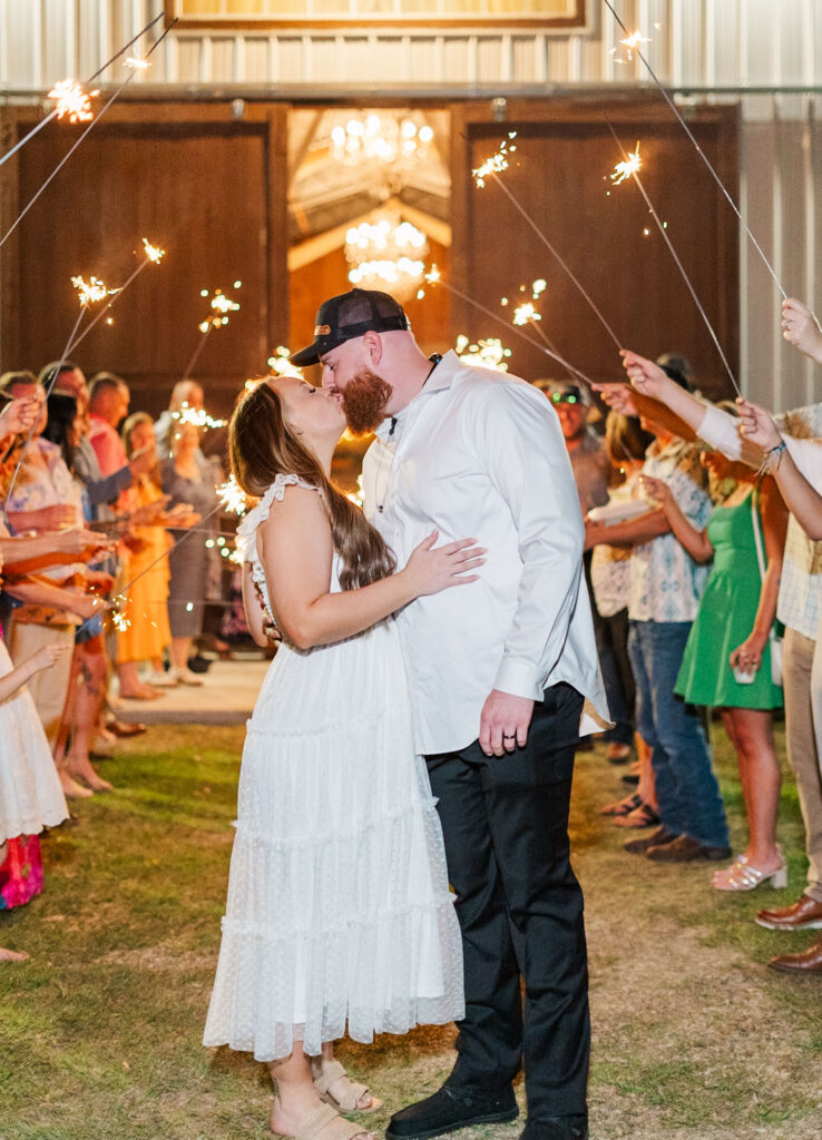 bride and groom kiss at the end of the sparkler exit 