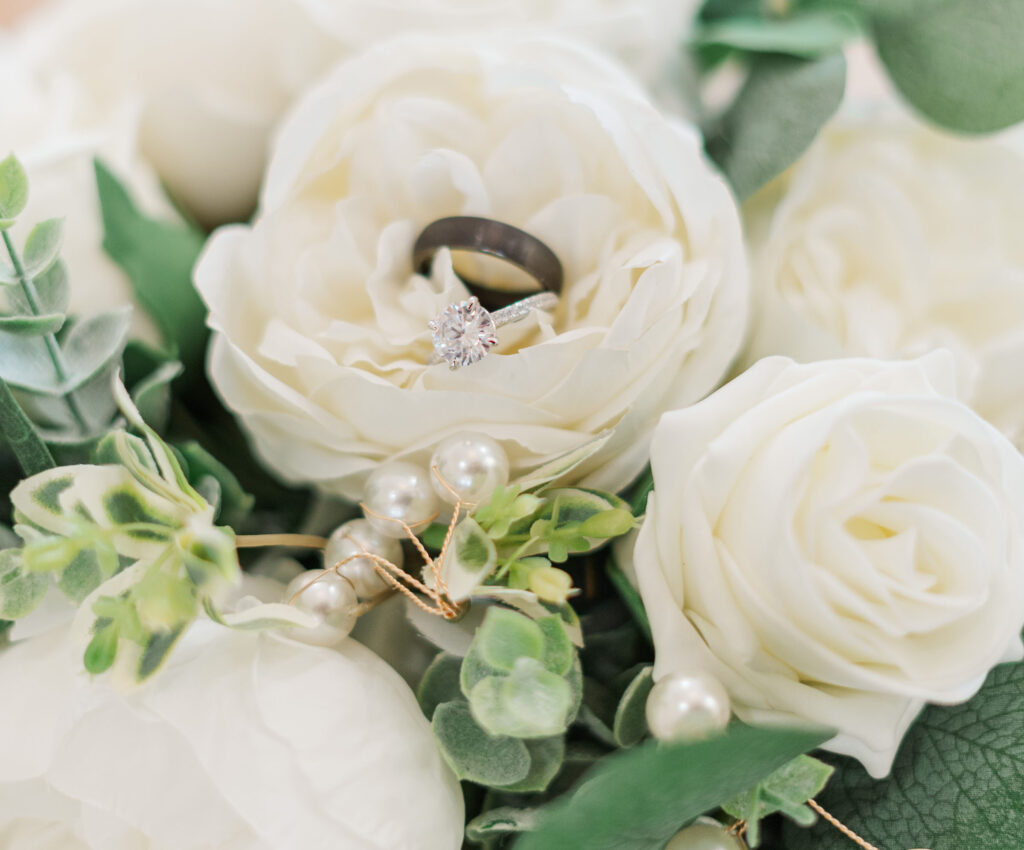 white flower with wedding rings