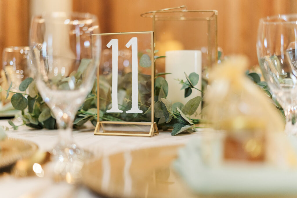 detail photo with the table number 11 and wine glasses