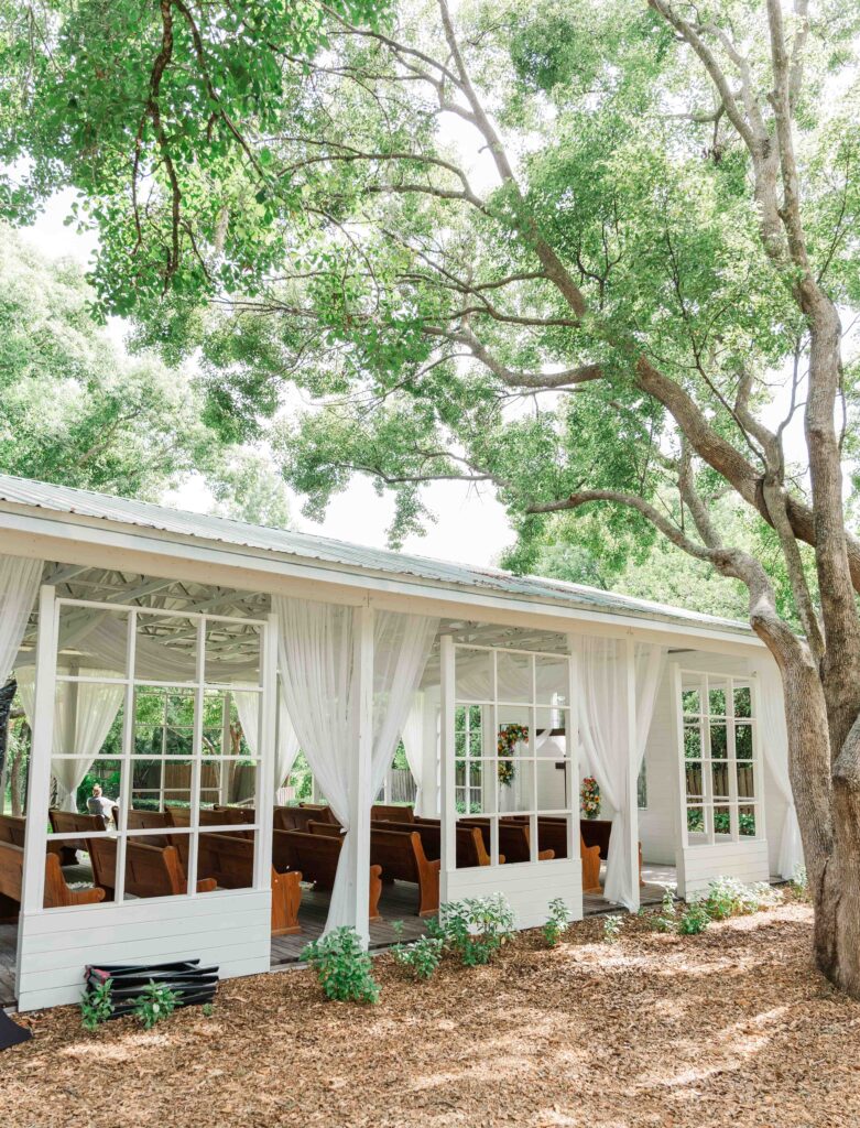 the chapel is surrounded tall trees