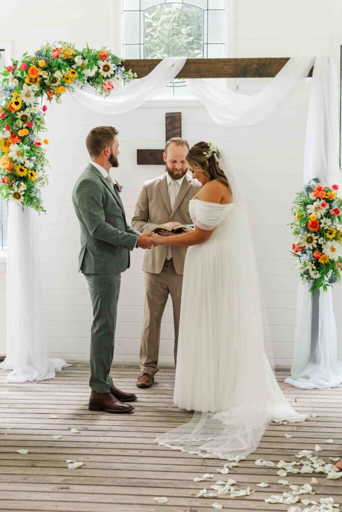 bride and groom at the alter