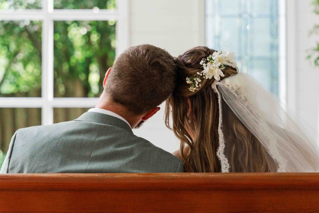 bride and groom posing in the chapel