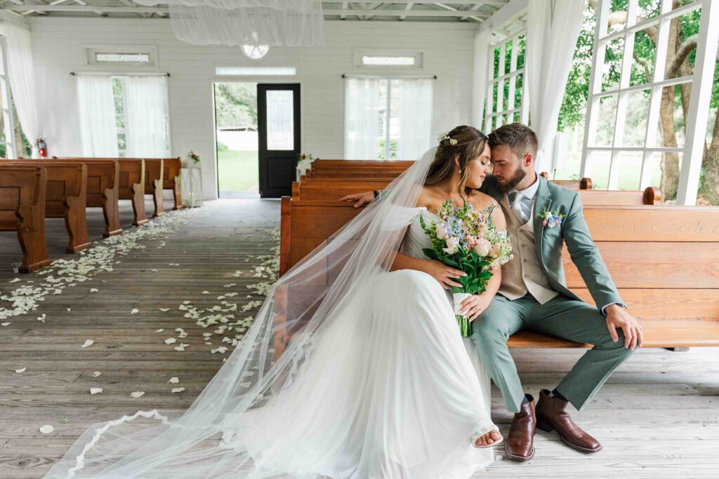 bride and groom posing in the chapel