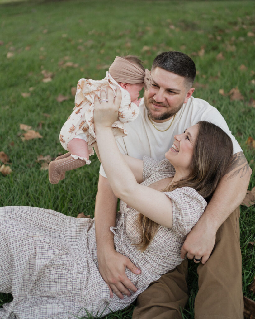 Lakeland family photographers parents playing with newborn.jpg